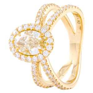 Gold ring with oval diamond and halo design.