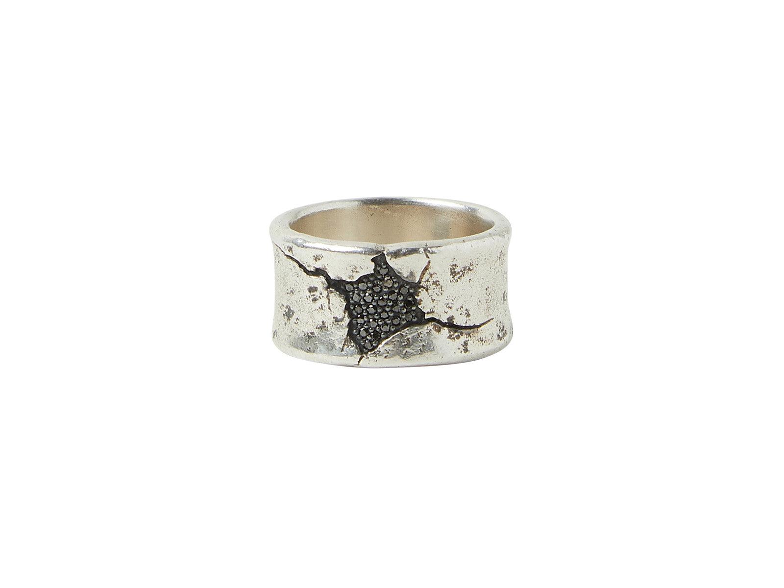Silver ring with textured black design