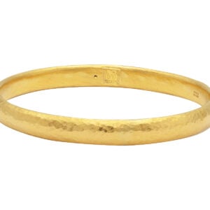 Gold hammered bangle bracelet isolated on white.