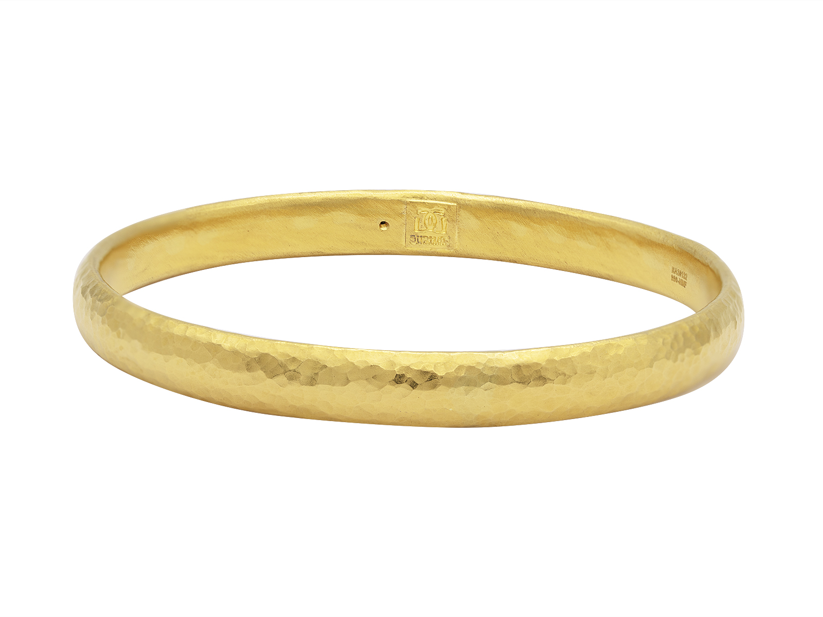 Gold hammered bangle bracelet isolated on white.