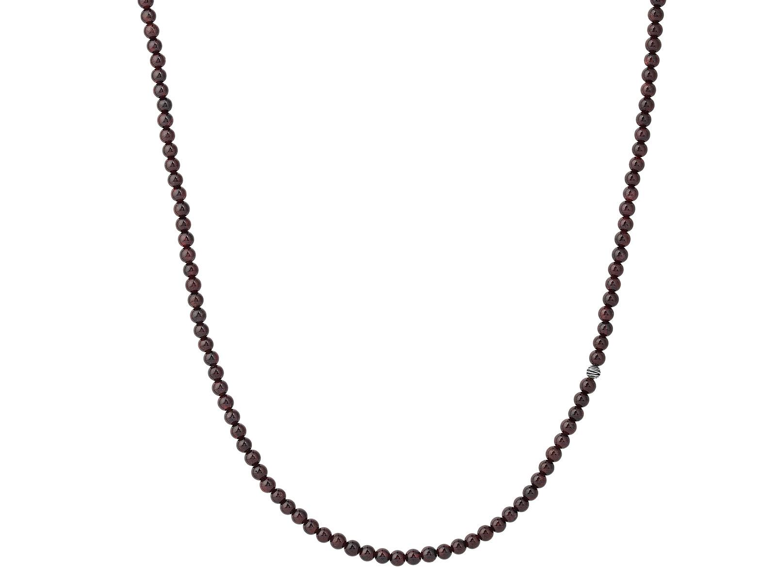 Dark beaded necklace on white background