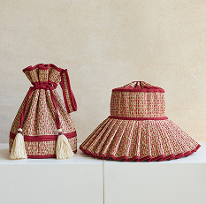 Two red patterned bags on a white surface.