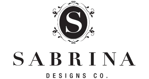 Sabrina Designs Co. logo with ornate 'S'.