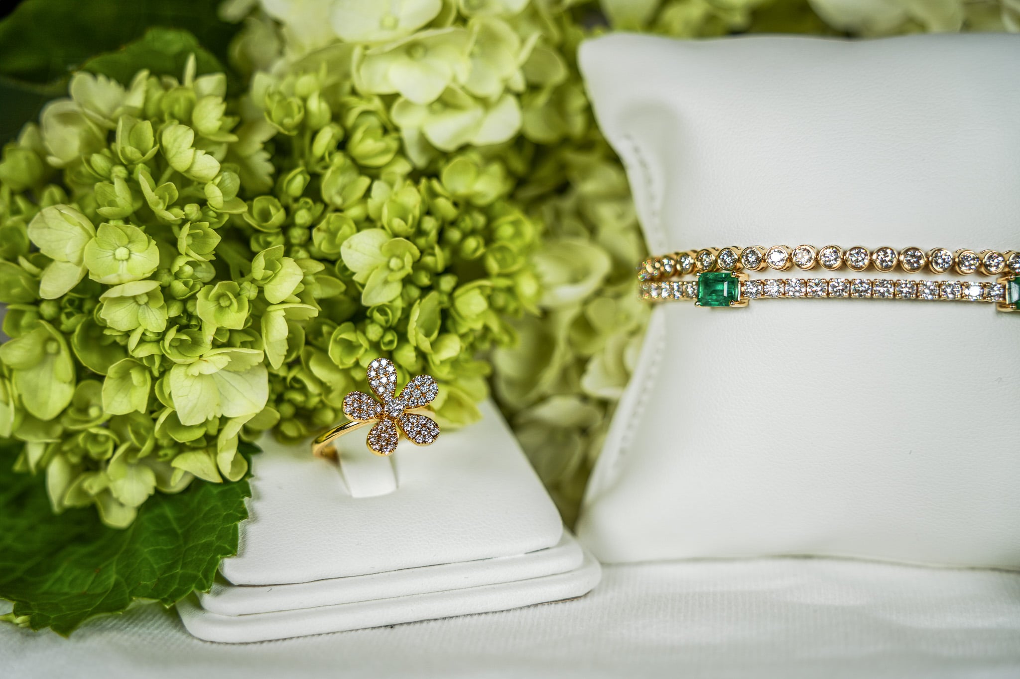 Elegant jewelry with green flowers backdrop