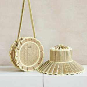 Woven bag and hat on white surface.