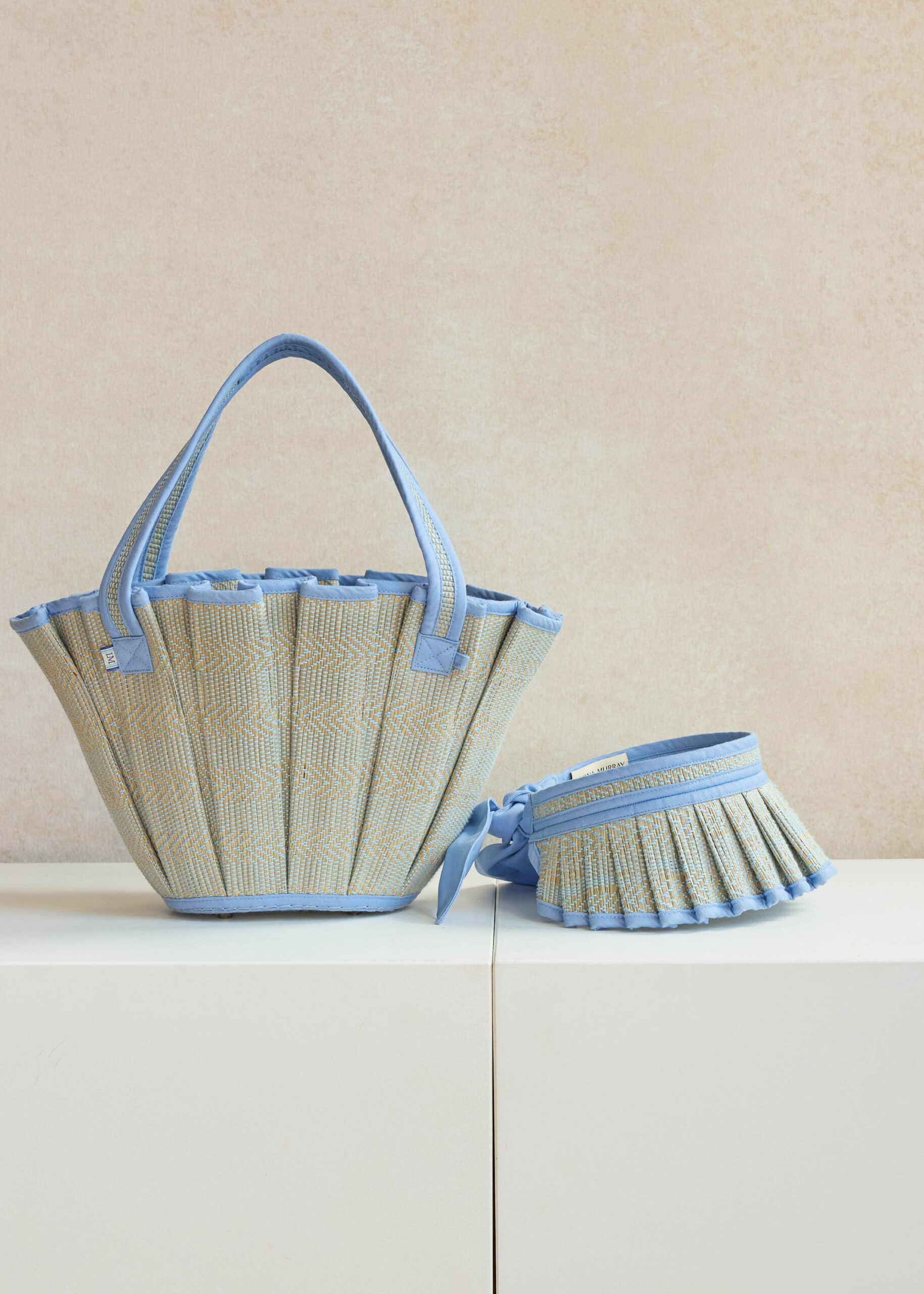 Elegant blue and beige woven bags on display.
